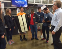 Engage/RISER LLC Students visit ONRL's Manufacturing Demonstration Facility and hold the 3D printed Shelby Hood signed by President Obama