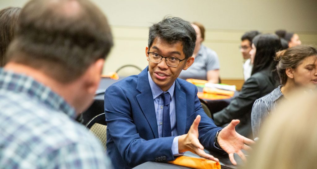 Student networking at a table during EPP Expo