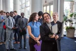 Student smiling while waiting in line